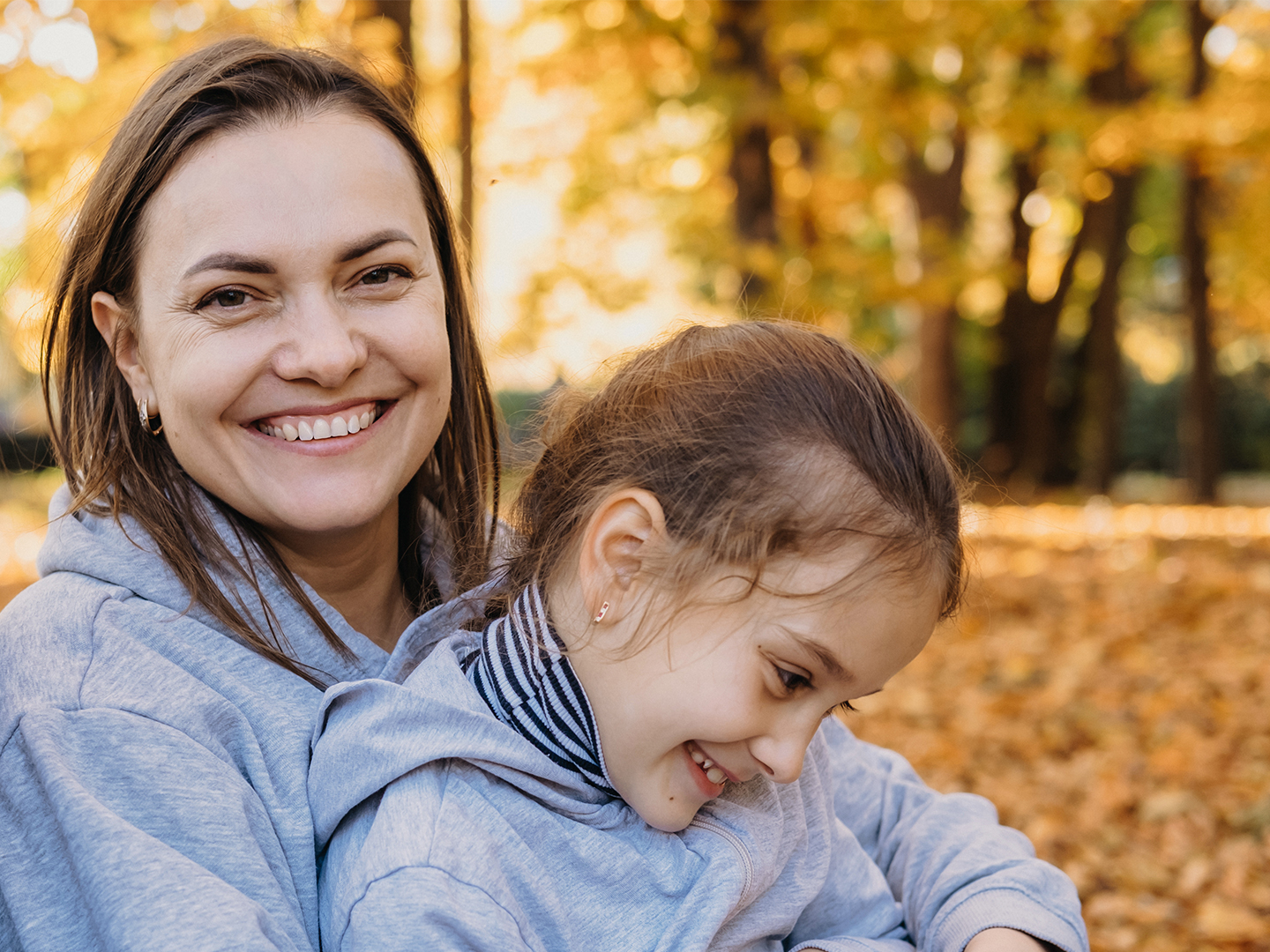 Woman in her 40s holding her daughter