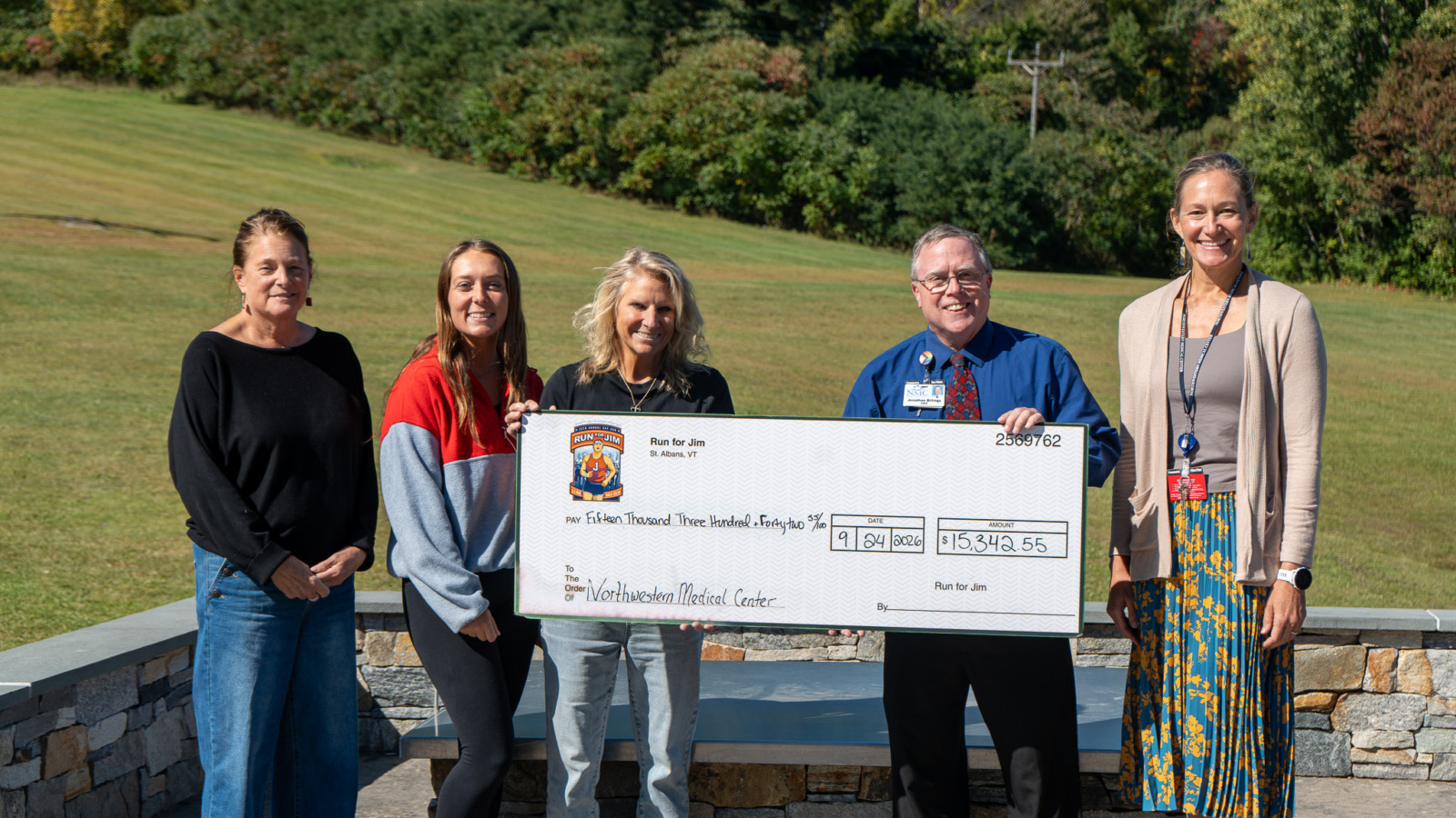 Members from Run for Jim planning, St. Albans Rec Department and Northwestern Medical Center staff gather for check presentation